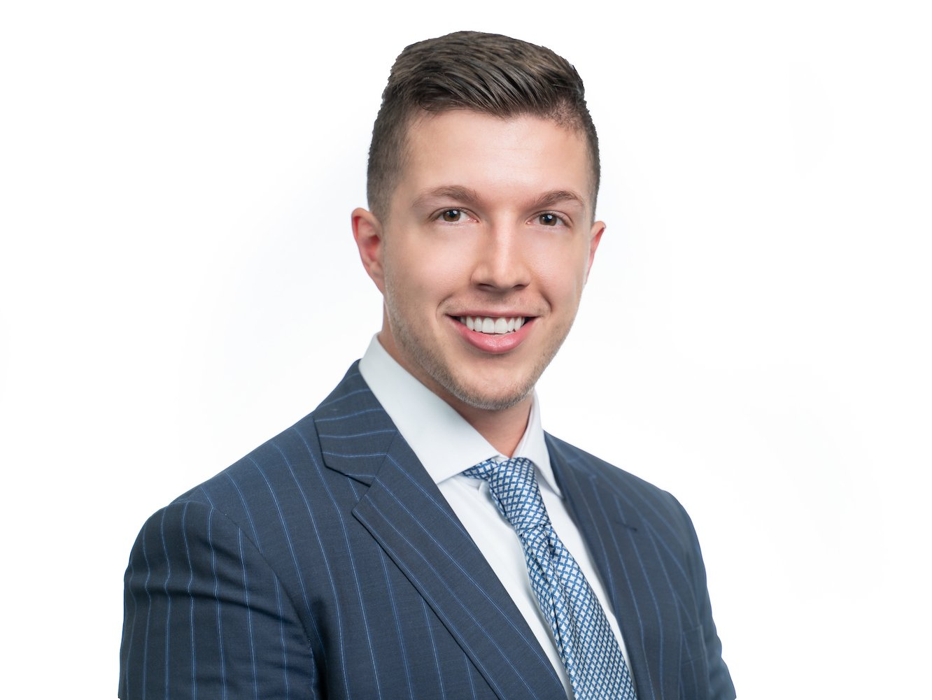 A man in a suit and tie is smiling for the camera.