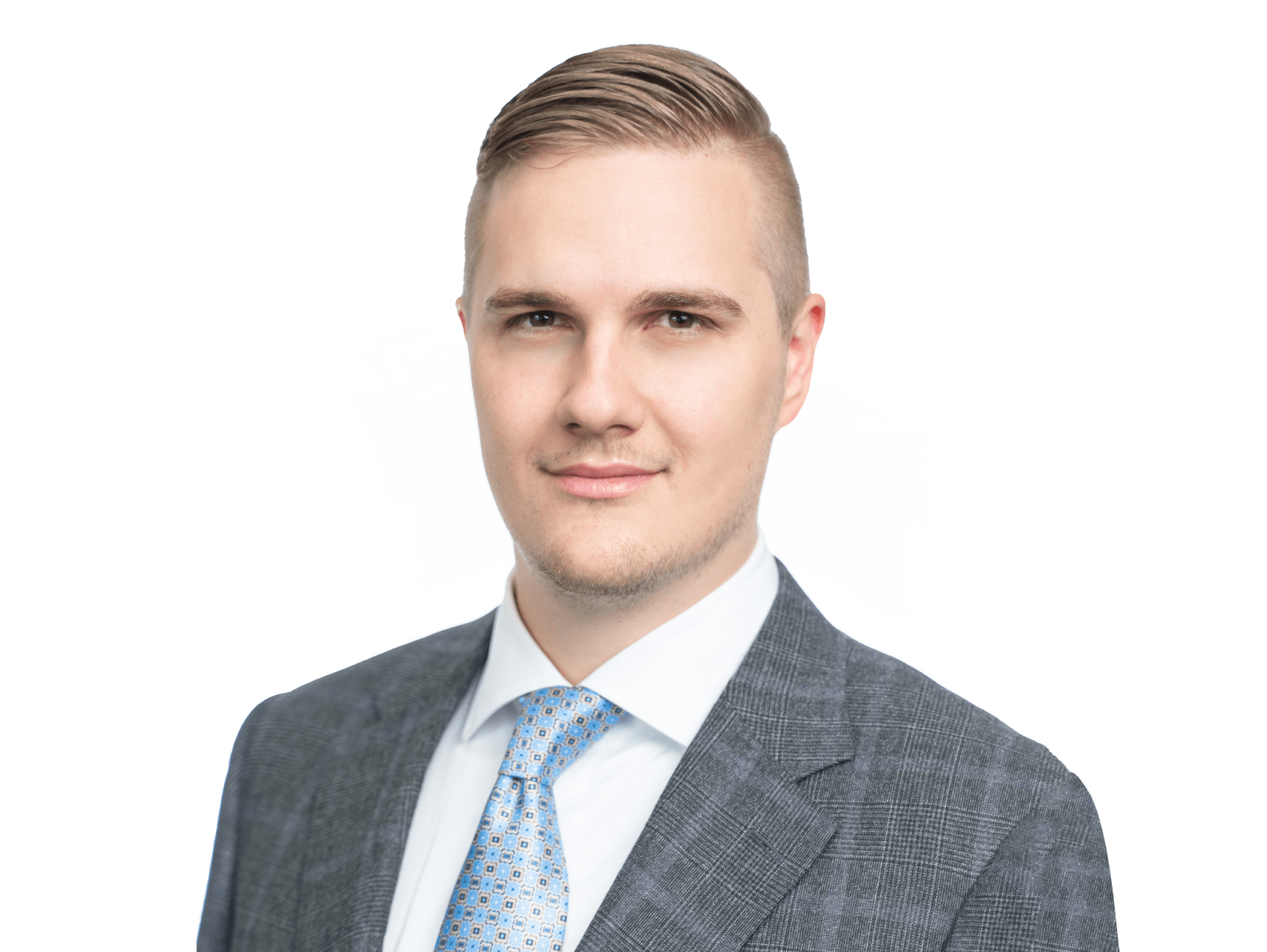 A man in a suit and tie is standing in front of a white background.